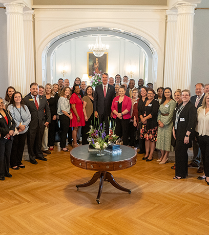 Governor Glenn Youngkin poses with a group of advocates at the Executive Mansion.