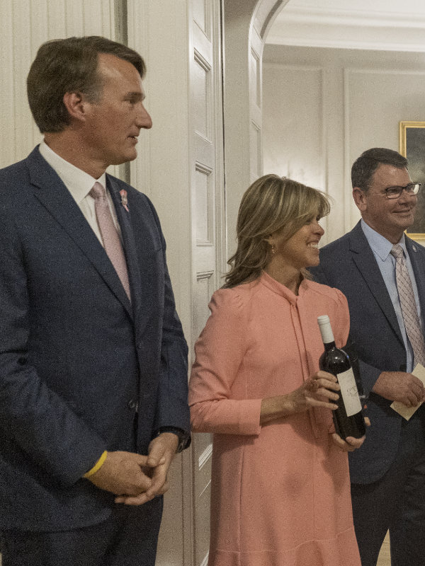 Gov and First Lady with wine bottle
