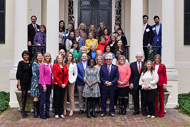 First Lady Suzanne S. Youngkin poses outside the Executive Mansion with a group.