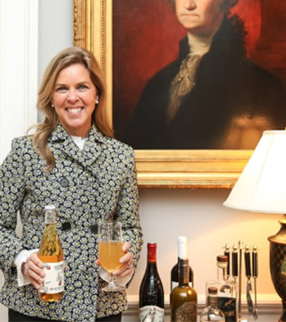 The First Lady holding a glass of Virginian cider.