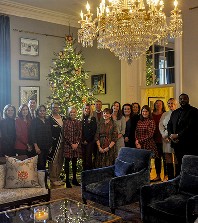 A group posing in front of a Christmas tree in the Executive Mansion.