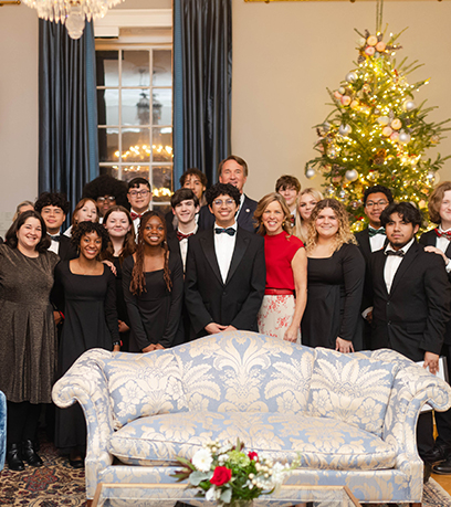The Governor and First Lady pose in the Executive Mansion with a high school choral group.