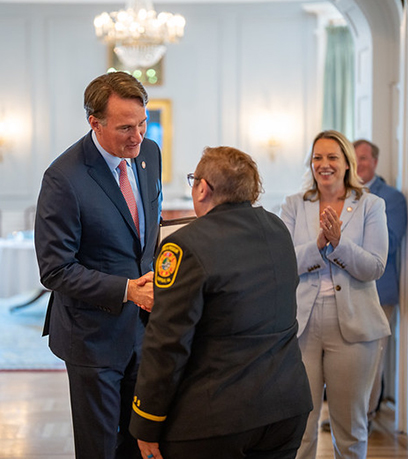 the Governor shaking hands with an emergency responder