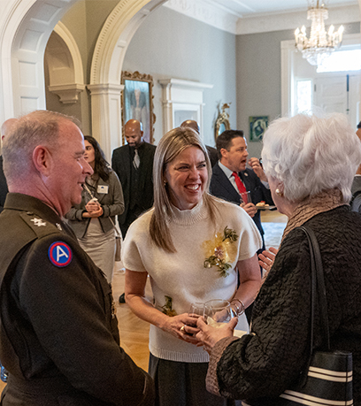 The First Lady smiles during a conversation between Major General Williams and the wife of a Virginia Vietnam War POW.
