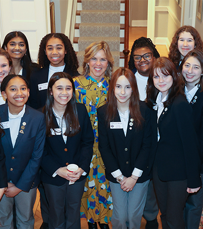 First Lady Suzanne S. Youngkin poses with a group of middle school-aged girls, members of the Virginia General Assembly Page Program.