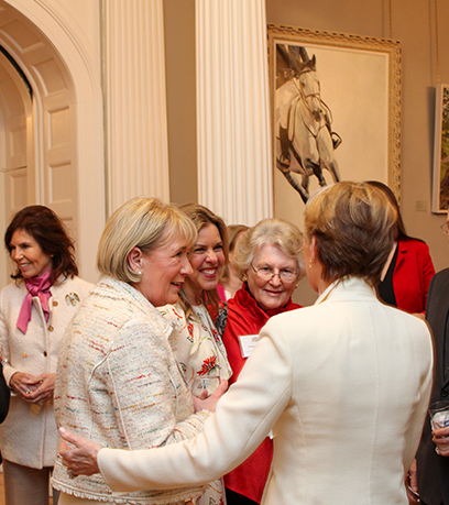 First Lady Suzanne S. Youngkin greets three women inside the Executive Mansion.