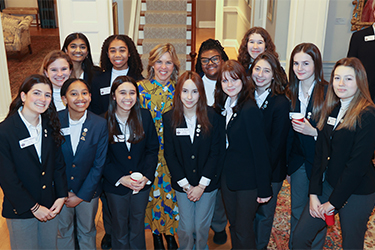 First Lady Suzanne Youngkin poses with young female members of the 2023 General Assembly Page Program.