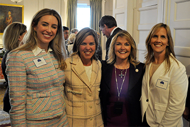 The First Lady of Virginia poses with Secretary of Commerce and Trade, Caren Merrick, as well as two female entrepreneurs.