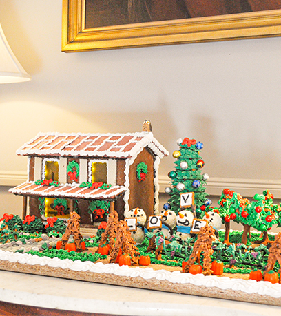 A gingerbread house decorated to look like a farmhouse.
