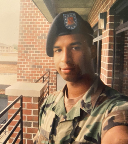 Young African American man in an army uniform posing for a selfie.