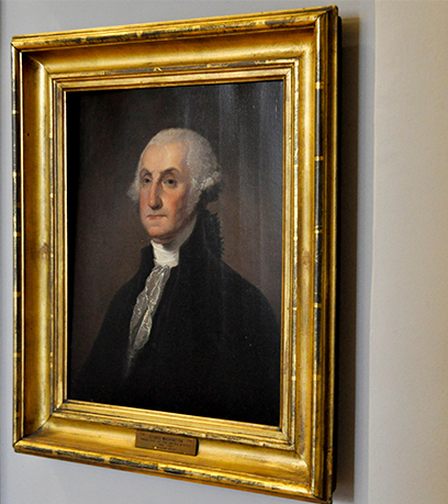 Portrait of George Washington in a gold frame.