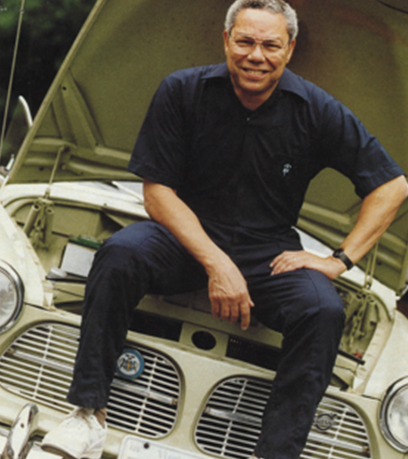 General Colin L. Powell sitting on top of a vintage Volvo.