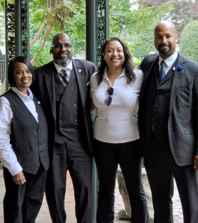 Townes family Stephanie, Tutti, Cherry, and Martin stand together with the Executive Mansion garden behind them.